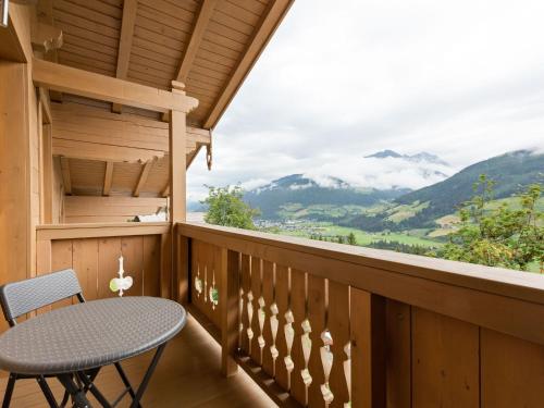 a balcony with a table and a view of mountains at Spacious Villa with Sauna in Mittersill in Mittersill