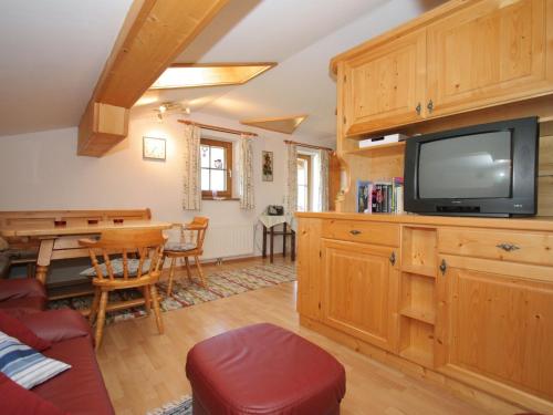 a living room with a tv and a table at Apartment in Embach Austria near ski area in Embach