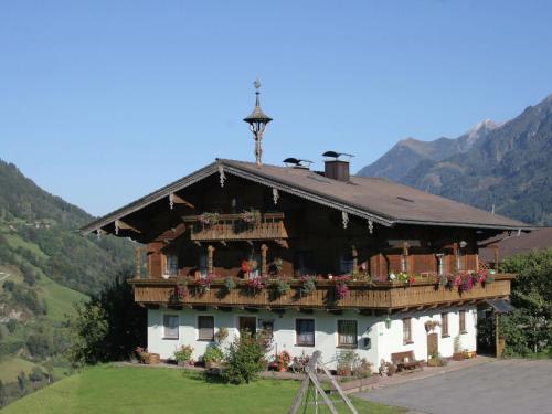 a large house with balconies and flowers on it at Apartment in Embach Austria near ski area in Embach