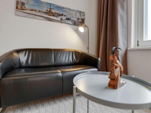 a living room with a leather couch and a table at Apartment in St Lambrecht near ski area in Sankt Lambrecht