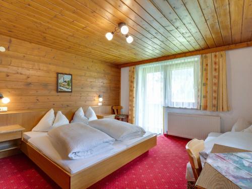 een slaapkamer met 2 bedden in een houten kamer bij Spacious Apartment in Tyrol with Mountain View in Kappl