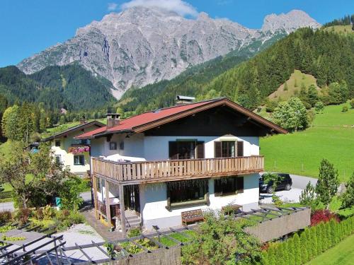 a house in the mountains with mountains in the background at Stylish authentic holiday home in Leogang Salzburgerland near ski area in Leogang