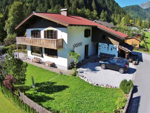 a house with a car parked in front of it at Stylish authentic holiday home in Leogang Salzburgerland near ski area in Leogang