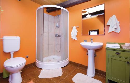 a bathroom with a shower and a toilet and a sink at Two-Bedroom Holiday Home In Ozalj in Ozalj
