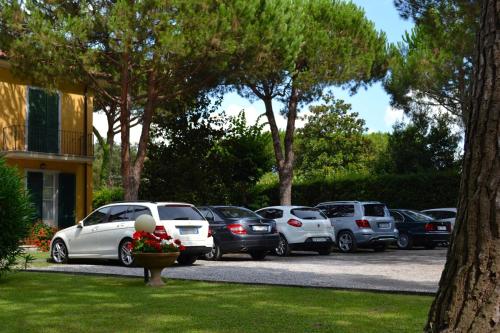 a group of cars parked in a parking lot at Hotel Villa Fiorisella in Marina di Massa