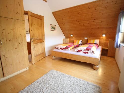 a bedroom with a bed and a wooden ceiling at Holiday home in Liebenfels in Carinthia with sauna in Liebenfels