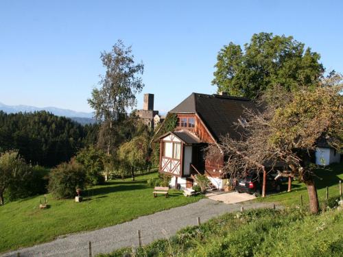 a house in the middle of a field with a house at Holiday home in Liebenfels in Carinthia with sauna in Liebenfels