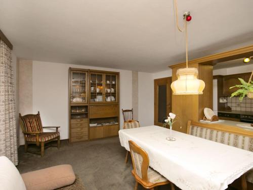 a dining room with a white table and chairs at Apartment in W ngle Tyrol with Walking Trails Near in Reutte