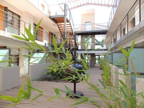 a courtyard of an apartment building with a spiral staircase at Adonis Aix en Provence in Aix-en-Provence