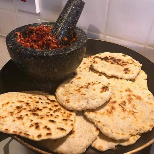 a plate of food with a bowl of salsa at Plantation Surf Inn & Restaurant - Midigama in Midigama