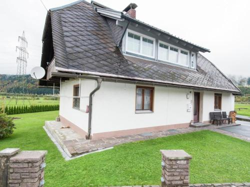 a white house with a black roof at Holiday apartment in Tr polach near Pressegger See in Tröpolach