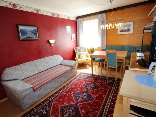 a living room with a couch and a dining room at Charming Apartment in Feld am See 100 m from Lake in Feld am See
