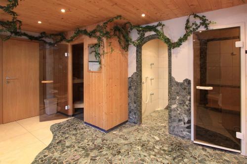 a room with a door and a wall with plants at Tonis Ferienheim in Sölden