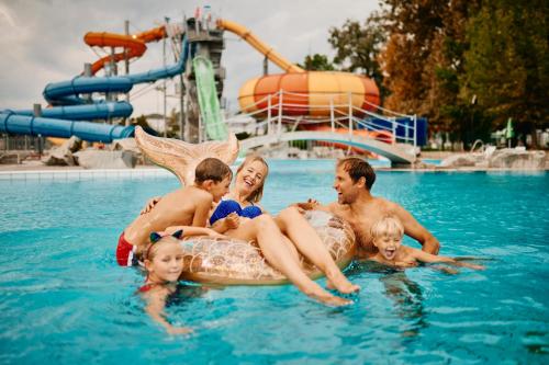 a group of people in the water on an inflatable at Apartments Čatež - Terme Čatež in Čatež ob Savi
