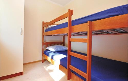 a bunk bed room with two bunk beds with blue sheets at Apartment Mimice With Sea View 382 in Mimice