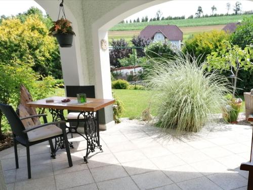 a patio with a table and chairs and a garden at Cosy Apartment in Oed hling with Garden in Mauer bei Amstetten