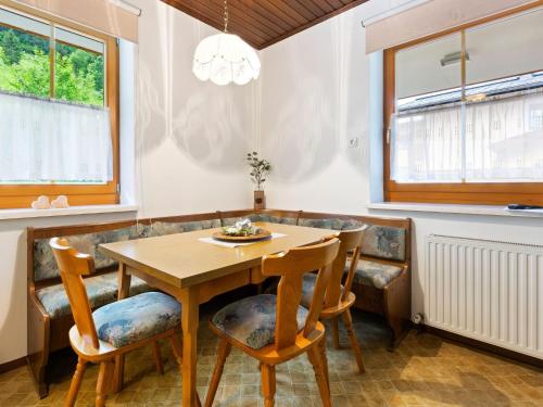 a dining room with a wooden table and chairs at Spacious Apartment in Grossarl with Garden in Grossarl