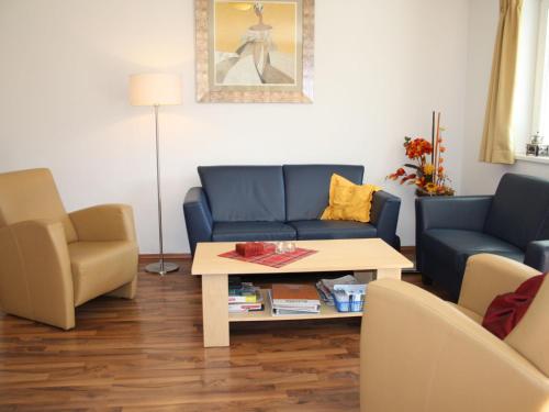 ein Wohnzimmer mit einem blauen Sofa und einem Tisch in der Unterkunft Apartment in Kaprun near ski lift in Kaprun