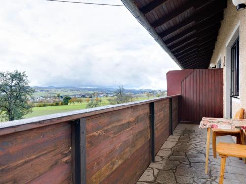 a balcony with a wooden fence and a table and chairs at Beautiful Holiday Home in Ulrichsberg with Balcony in Ulrichsberg