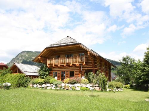 a log cabin with a porch and a balcony at Detached holiday home in Mauterndorf Salzburgerland near the ski area in Mauterndorf
