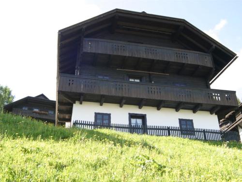 a wooden building on top of a hill at Apartment in Nassfeld Carinthia with sauna and pool in Schlanitzen