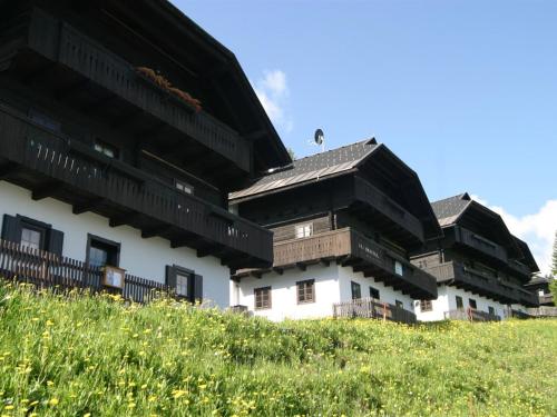 a group of buildings on top of a hill at Apartment in Nassfeld Carinthia with sauna and pool in Schlanitzen