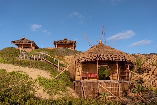 a group of huts on top of a hill at Bela Flor Beach Front Apartments in Inhambane