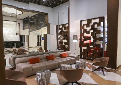 a living room with a couch and chairs at The Key Beirut in Beirut