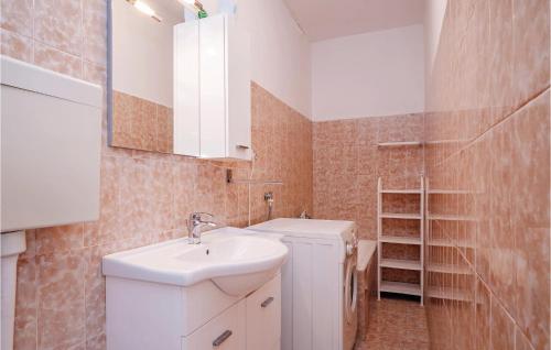 a small bathroom with a sink and a mirror at Awesome Apartment In Turanj With Kitchen in Turanj