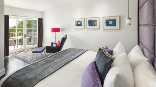 a bedroom with a large bed and a couch at Camden Harbour Inn a member of Small Luxury Hotels in Camden