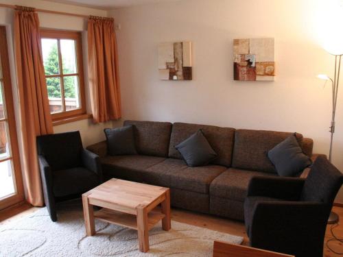 a living room with a couch and two chairs and a table at Apartment with Sauna near Ski Slopes in Mittersill in Hollersbach im Pinzgau