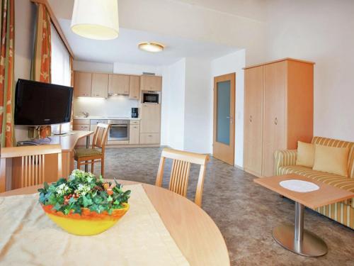 a kitchen and a living room with a table at Apartment in Kaltenbach near Ski Lift in Stumm