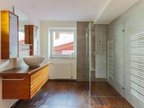 a bathroom with a sink and a glass shower at Chalet in Krimml near Zillertal Slopes in Krimml