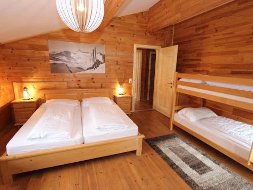 クリムルにあるComfortable Chalet with Whirlpool and Sauna in Krimmlのキャビン内のベッドルーム1室(二段ベッド2組付)