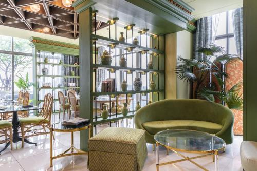 a room with a shelf with vases on it at Wyndham Bangkok Queen Convention Centre in Bangkok