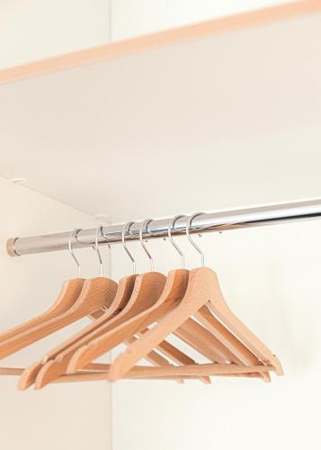 a rack of wooden hangers in a closet at Ring Stop Holiday Apartment in Sigulda
