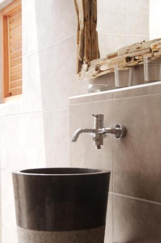 a bathroom with a sink and a faucet at Bantopa Apartments in Willemstad