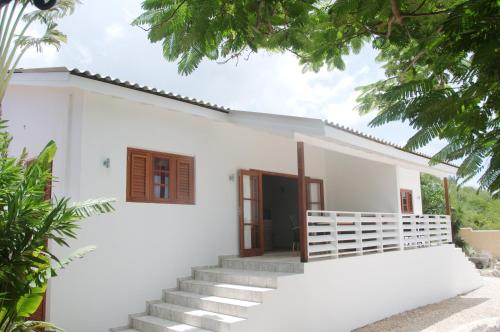 a white house with stairs in front of it at Bantopa Apartments in Willemstad