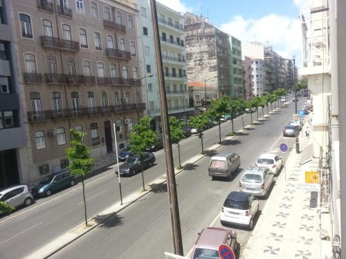 a city street filled with parked cars and buildings at Lisbon Gambori Hostel in Lisbon