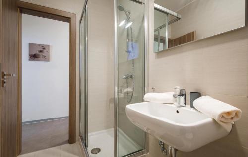a bathroom with a sink and a glass shower at Gorgeous Apartment In Novigrad With Kitchen in Novigrad Istria
