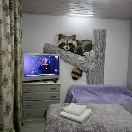 a cat laying on a tree shelf in a bedroom at Три горішки in Yaremche