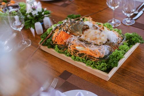 a plate of food on a wooden table at Blue Canyon Country Club in Mai Khao Beach