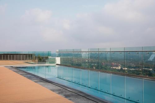 a swimming pool on the roof of a building at The Capital Trilogy Menlyn Maine in Pretoria