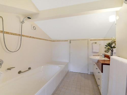 a white bathroom with a tub and a sink at Sydney View - Stay 3 Pay 2 in Woodford