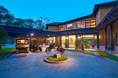 a house with a statue in front of it at Las Lagunas Boutique Hotel in Flores