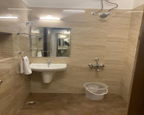 a bathroom with a sink and a toilet at CORAL RESIDENCY in Rāmanāthapuram