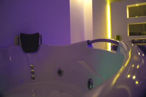 a bathroom with a white tub and a sink at La Bella Trani - Suites and B&B in Trani