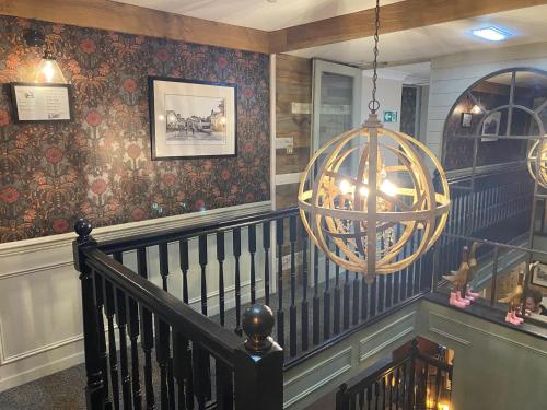 a spiral staircase with a chandelier in a house at The Inn At Grasmere in Grasmere