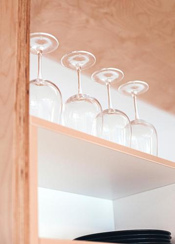 a shelf with wine glasses on top of it at Ring Stop Holiday Apartment in Sigulda