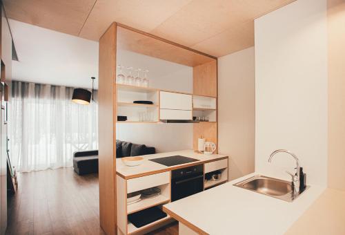 a small kitchen with a sink and a counter top at Ring Stop Holiday Apartment in Sigulda